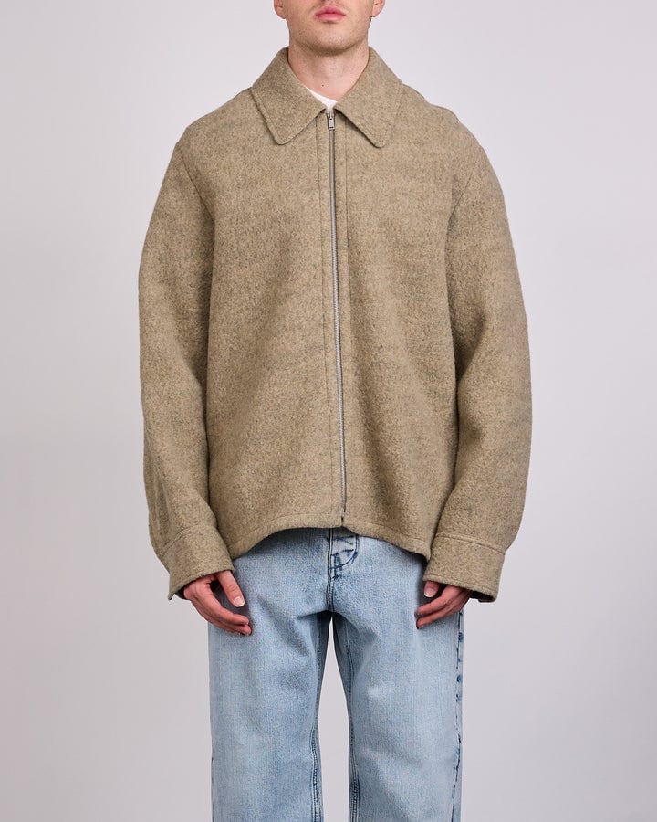 Model wearing the Jil Sander Felted Wool Melange Zip Jacket in fern, photographed by LESS 17